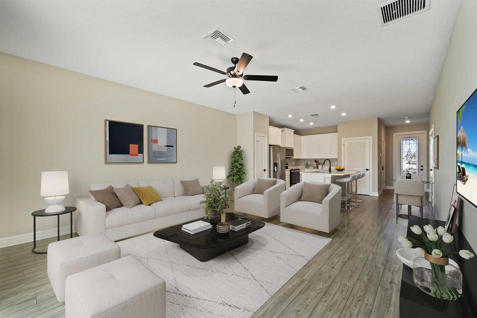 A bright open-concept living room features a white sofa, two armchairs, and a modern kitchen — 1817 Party Place, Fort Pierce FL 34947, FORT PIERCE, FL