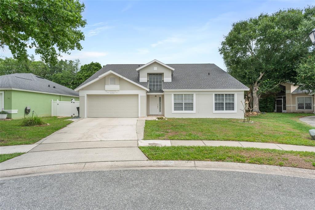 A single-story suburban house with a two-car garage, light-colored siding, and a gray roof — 632 HERONS NEST COURT, ORLANDO, FL