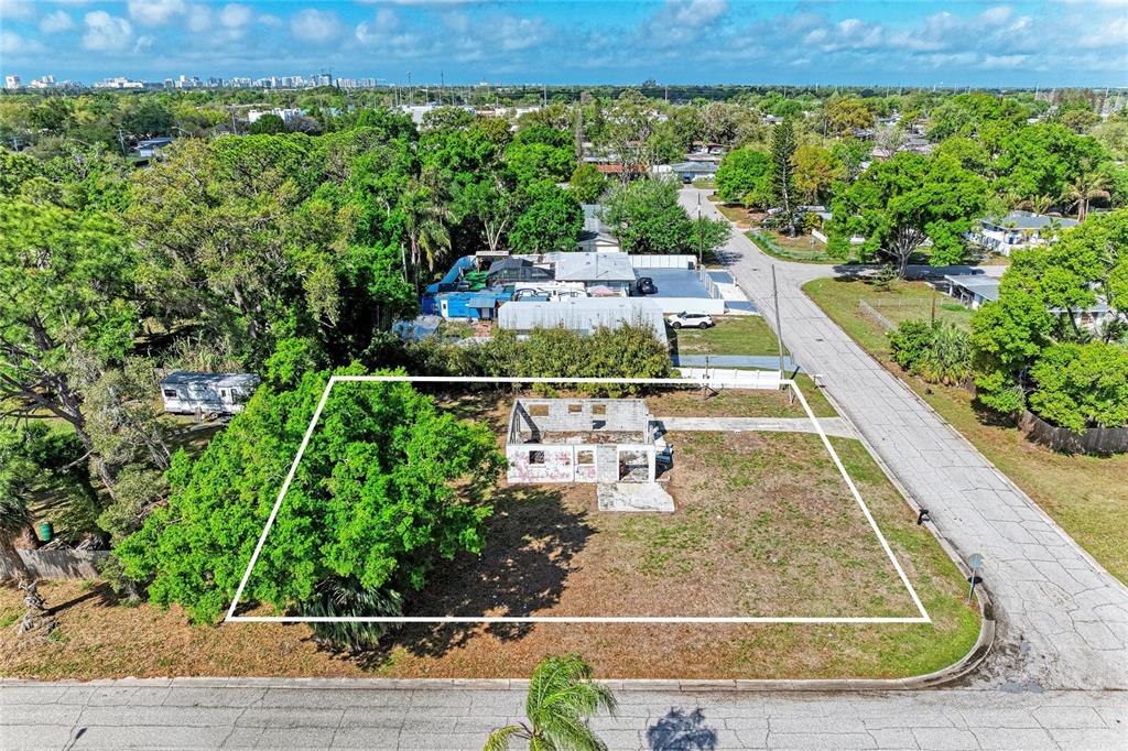 An aerial view shows a vacant lot with a ruined structure and a large tree — 0 DOVER STREET, SARASOTA, FL