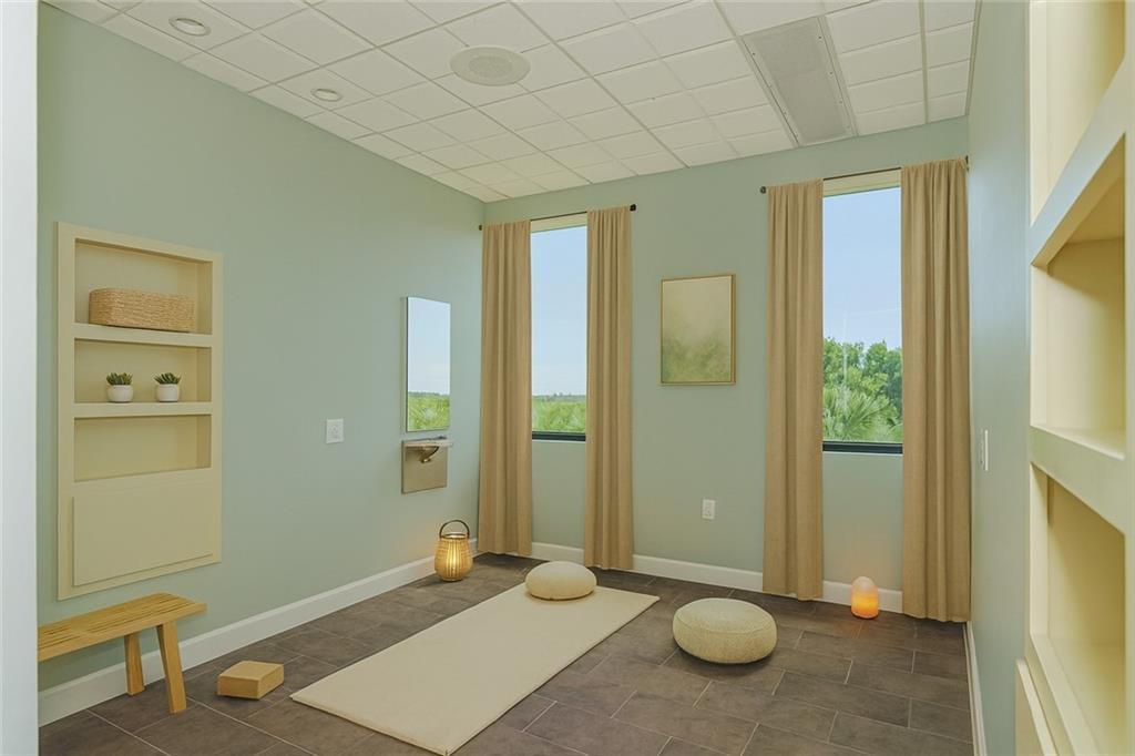 A yoga or meditation room with light green walls, a yoga mat, and two windows — 3755 7th Terrace, Vero Beach FL 32960, VERO BEACH, FL