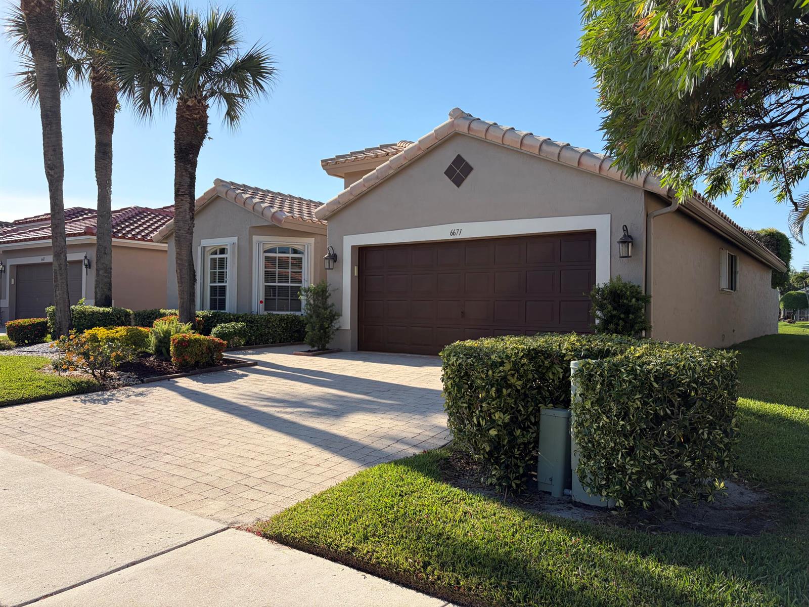 A single-story house with a brown garage door, tile roof, and landscaped front yard — 6671 Maybrook Road, Boynton Beach FL 33437, BOYNTON BEACH, FL