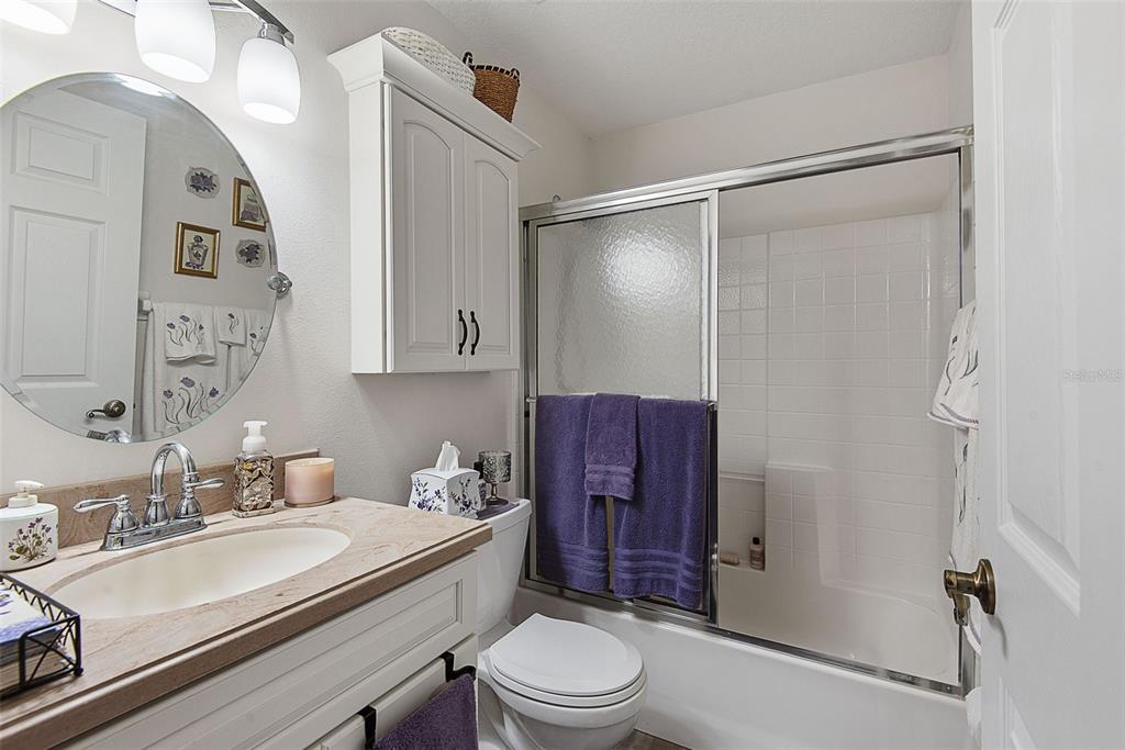 A bathroom features a vanity with a sink, a toilet, and a shower-tub combination — 210 ULLIAN TRAIL, PALM COAST, FL