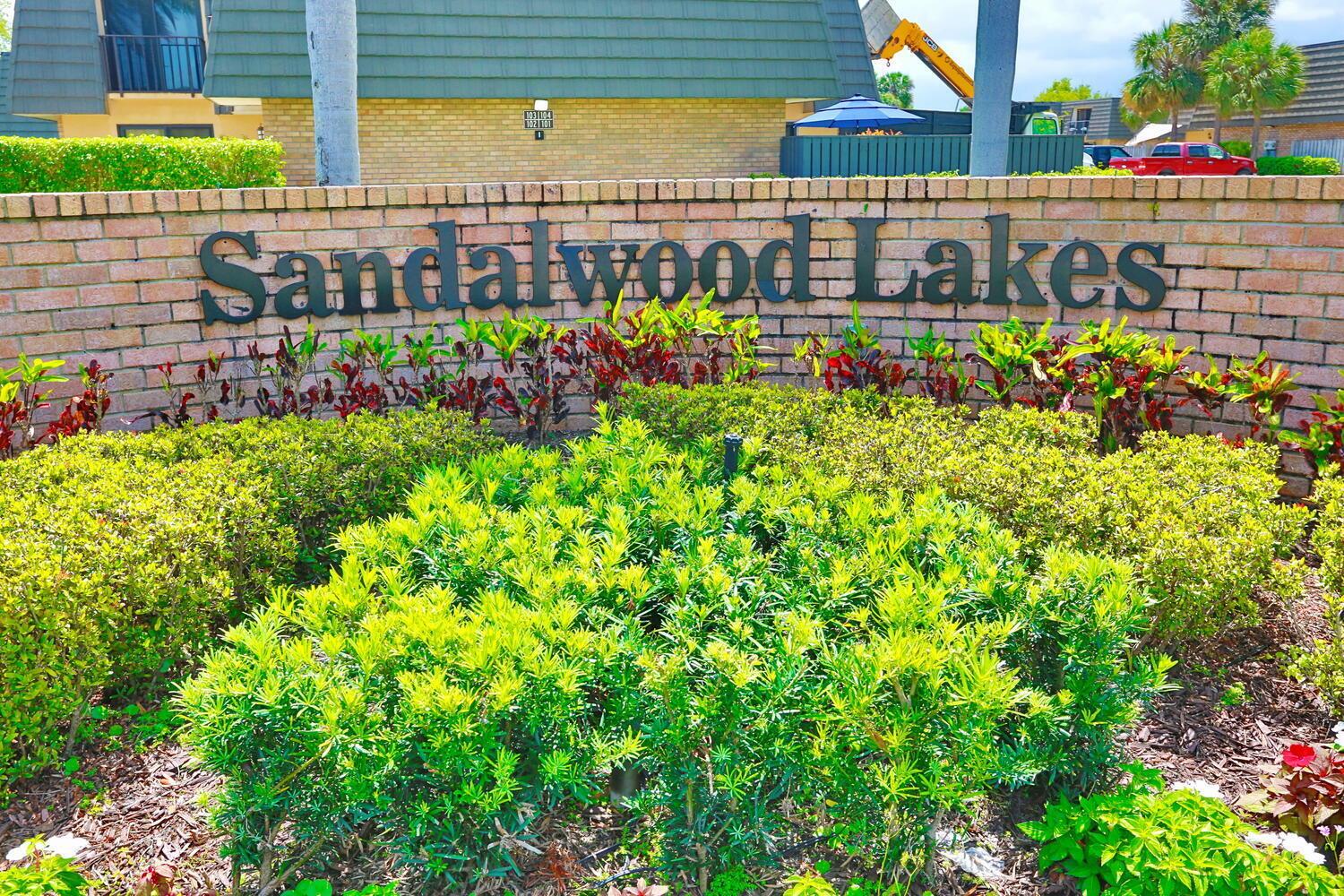A brick sign for Sandwood Lakes sits in front of a multi-story apartment building — 325 3rd Way, West Palm Beach FL 33407, WEST PALM BEACH, FL