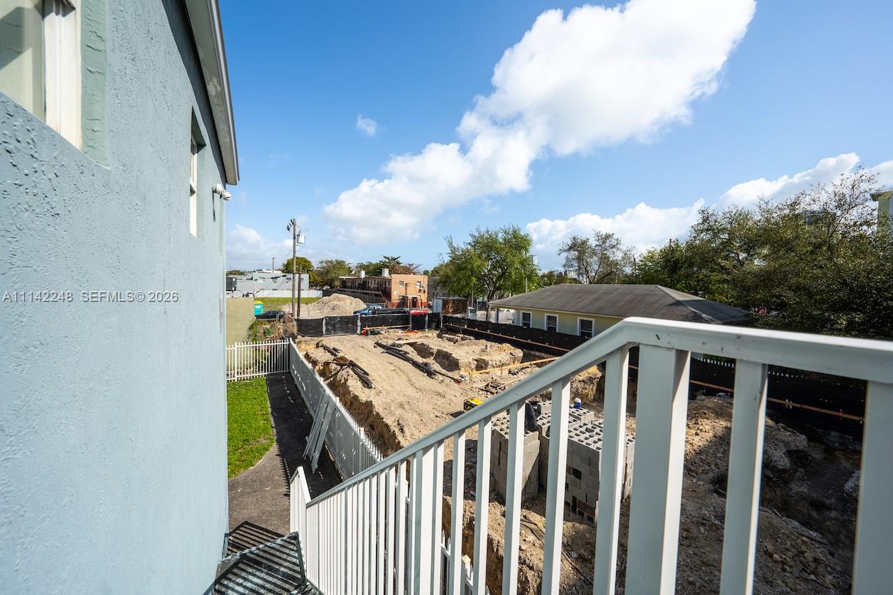 An elevated view shows a construction site with excavated ground and concrete blocks next to stairs — 1525 NW 3rd Ave, Miami FL 33136, MIAMI, FL