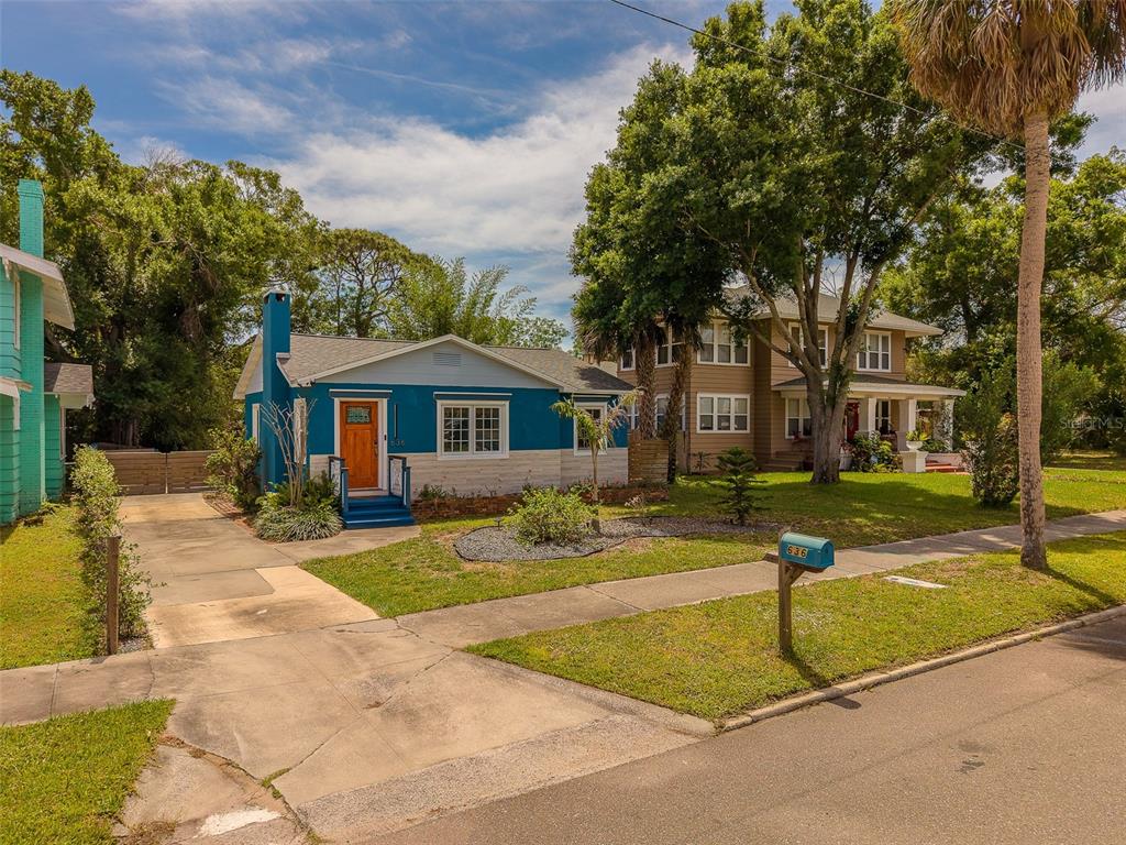 A blue and white single-story house with a driveway and a mailbox sits on a lawn — 636 37TH AVENUE S, ST PETERSBURG, FL