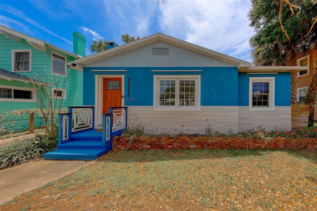 A blue house with a brick planter box and a wooden front door — 636 37TH AVENUE S, ST PETERSBURG, FL