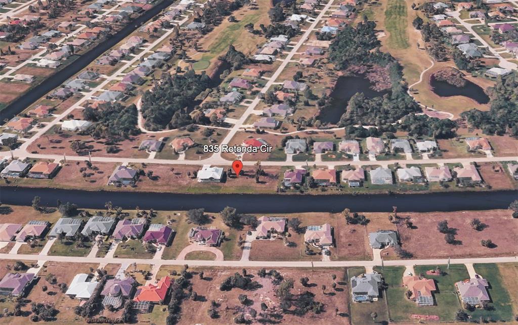 This aerial map view shows a residential neighborhood with houses situated along a canal — 835 ROTONDA CIRCLE, ROTONDA WEST, FL
