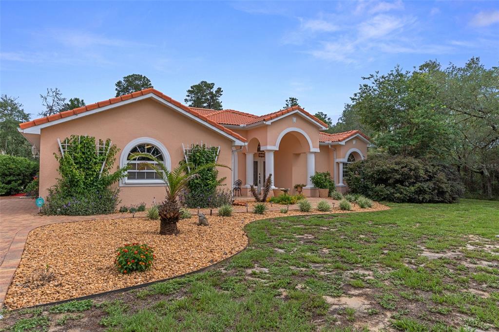 A single-story peach-colored house with a tile roof and a landscaped front yard — 4525 W ALAMO DRIVE, BEVERLY HILLS, FL