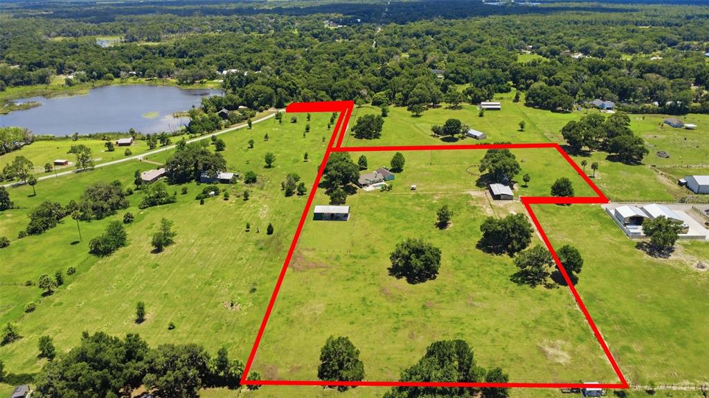 An aerial view shows a rural property with a house and outbuildings outlined in red — 1200 N HART ROAD, GENEVA, FL