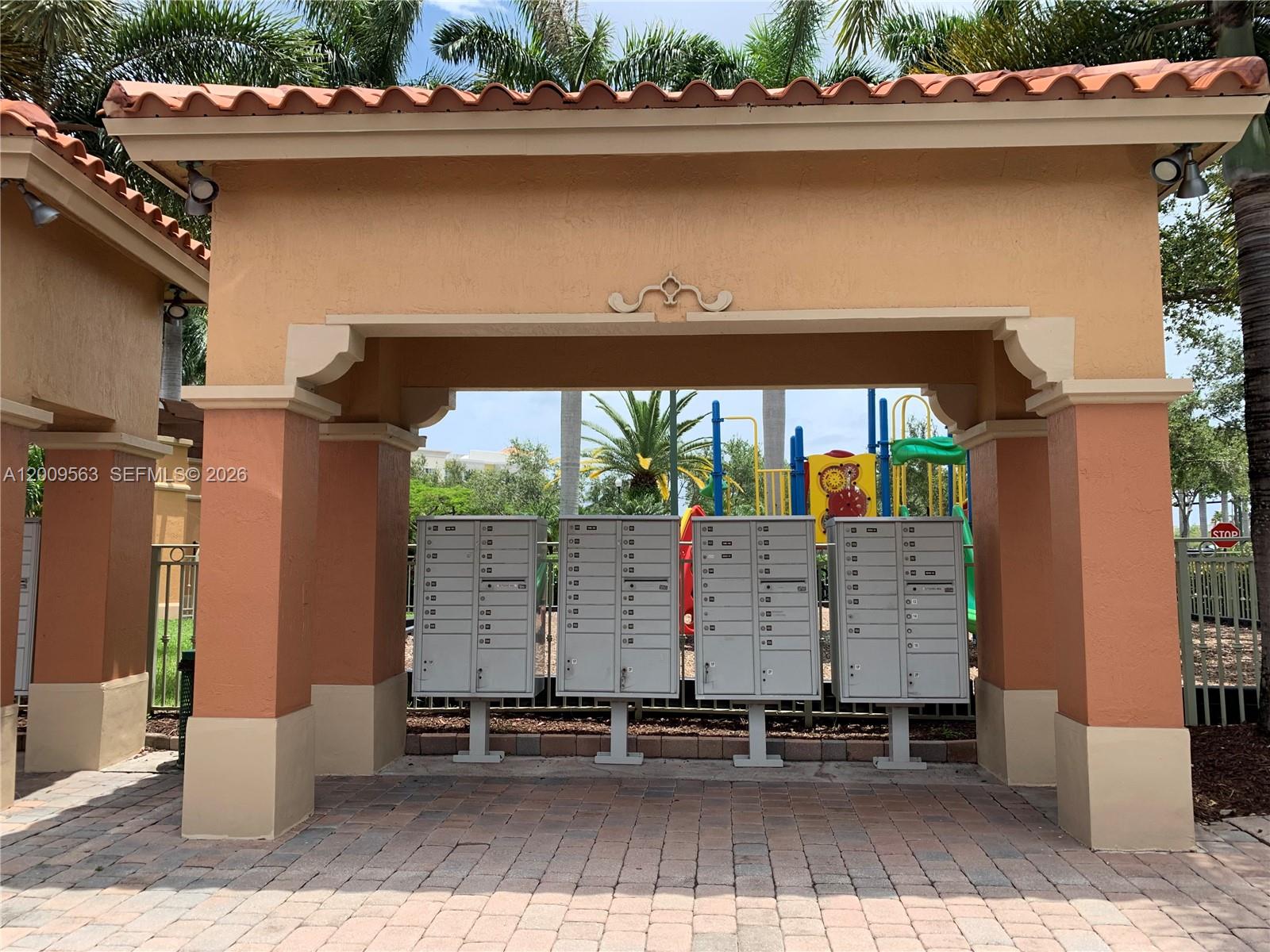 A covered outdoor area features four metal mailbox units standing on a paved patio — 4944 Windward Way # 1401, Dania Beach FL 33312, DANIA BEACH, FL