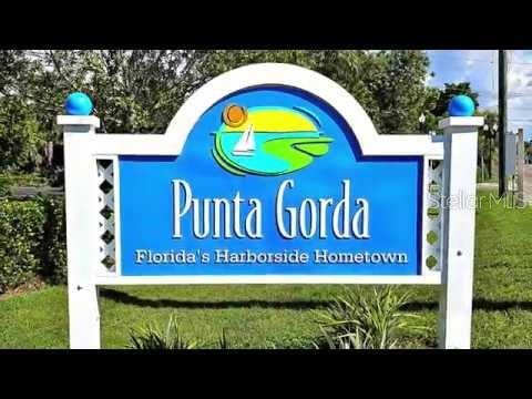 A white sign with blue lettering identifies the city of Punta Gorda, Florida — 151 GLENHOLM AVENUE, PUNTA GORDA, FL