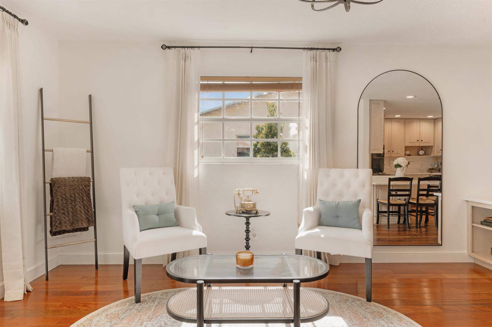 A bright living area features two white tufted chairs, a glass coffee table, and a mirror — 7416 Overlook Drive, Lake Worth FL 33467, LAKE WORTH, FL