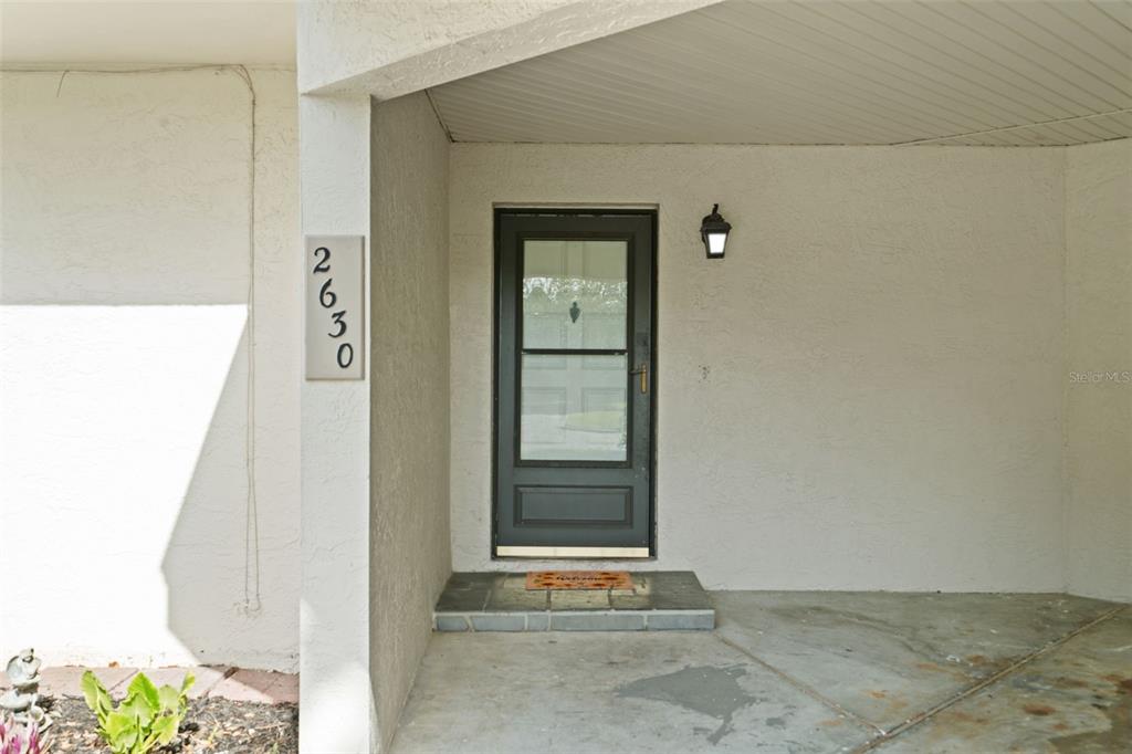 A front entryway features a dark door with a glass panel and house number 2630 — 2630 CEDAR VIEW COURT UNIT 0, CLEARWATER, FL