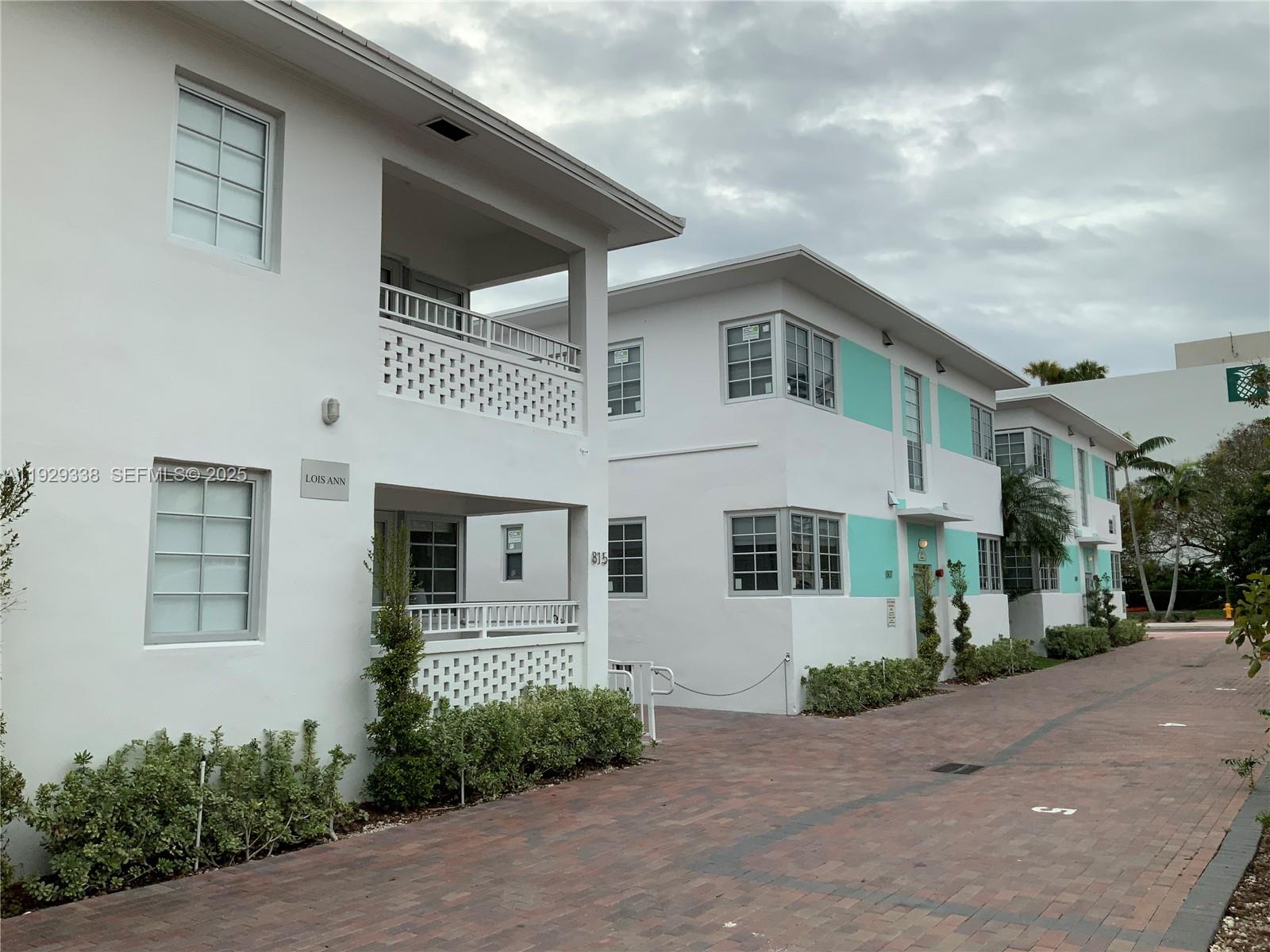 The exterior of a two-story white apartment building features balconies with decorative concrete block railings — 807 Alton Rd, Miami Beach FL 33139, MIAMI BEACH, FL