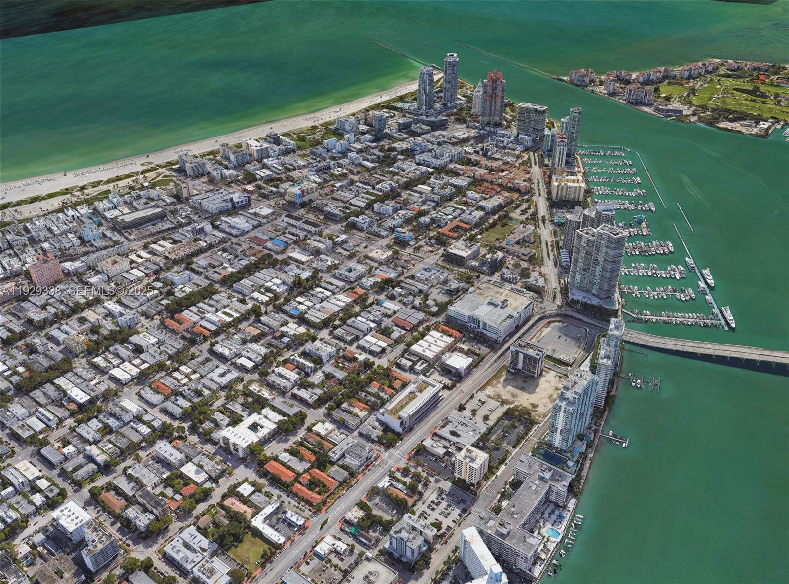 An aerial view shows a dense urban neighborhood along a coastline with a marina and bridge — 807 Alton Rd, Miami Beach FL 33139, MIAMI BEACH, FL