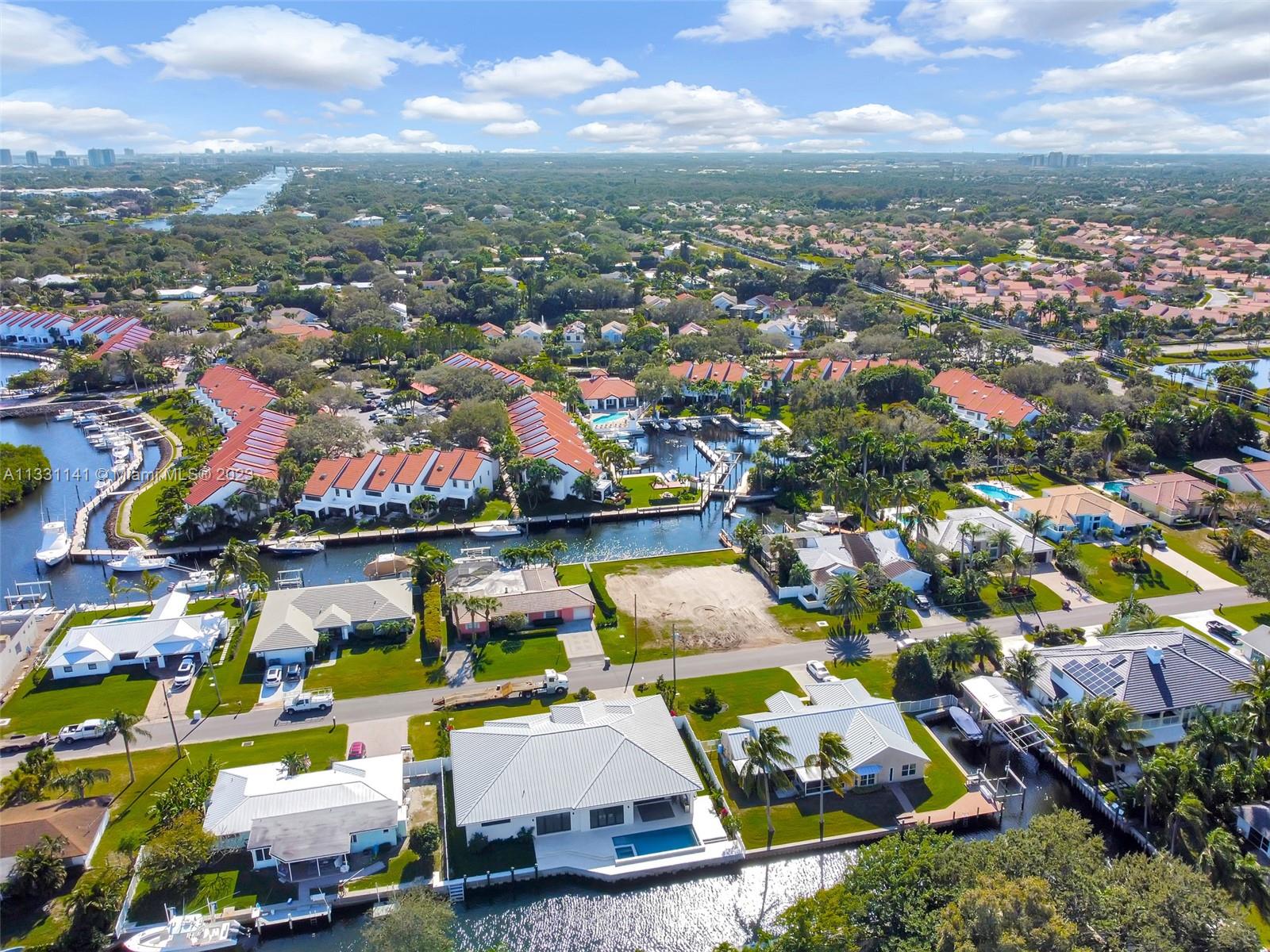 An aerial view shows waterfront homes with pools and boat docks in a suburban neighborhood — 2400 Edward Rd, Palm Beach Gardens FL 33410, PALM BEACH GARDENS, FL