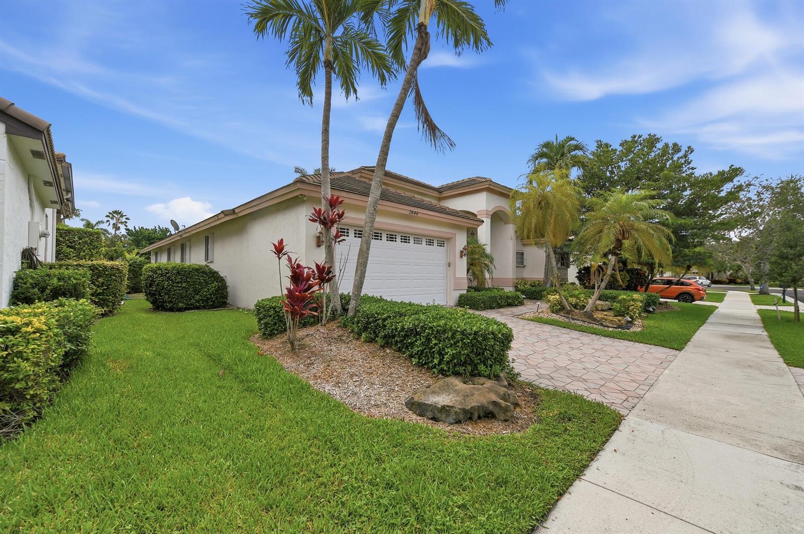 A single-story house with a white garage, palm trees, and a paved driveway — 2644 Miller Court, Weston FL 33332, WESTON, FL