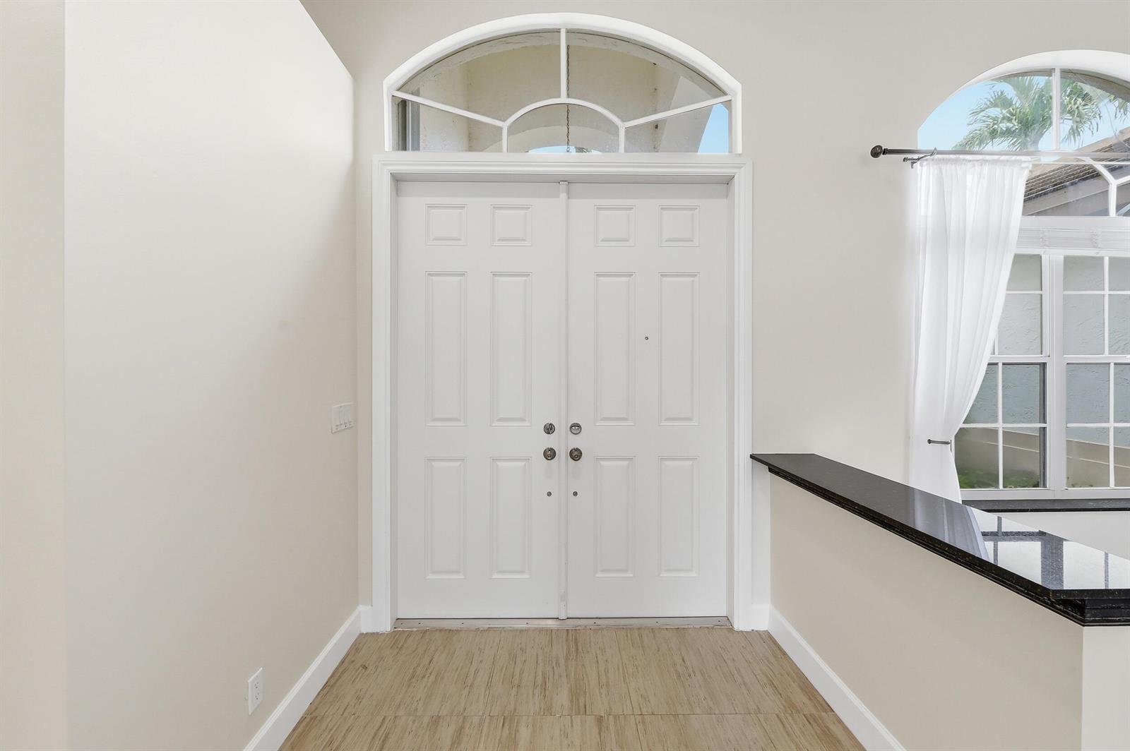 A white double front door with a transom window sits in a tiled entryway — 2644 Miller Court, Weston FL 33332, WESTON, FL