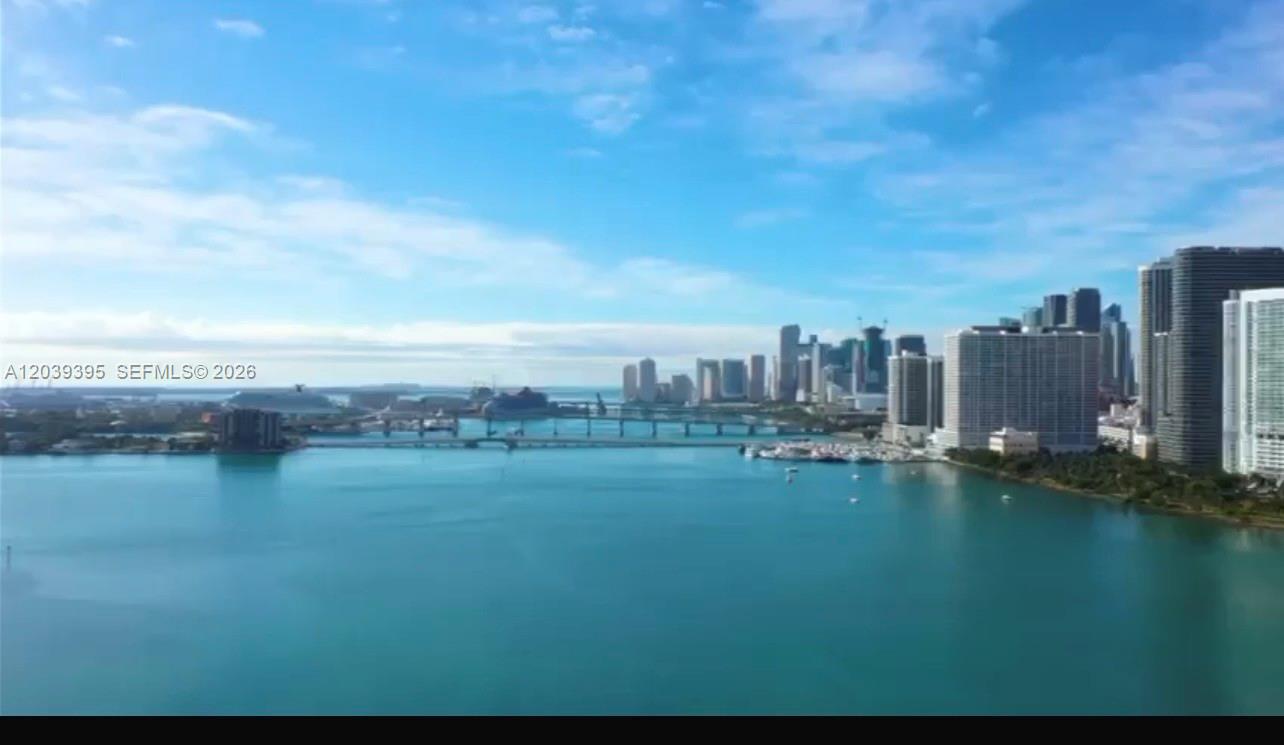 An aerial view of a blue bay with a bridge and a city skyline — 700 NE 24th St # 1505, Miami FL 33137, MIAMI, FL
