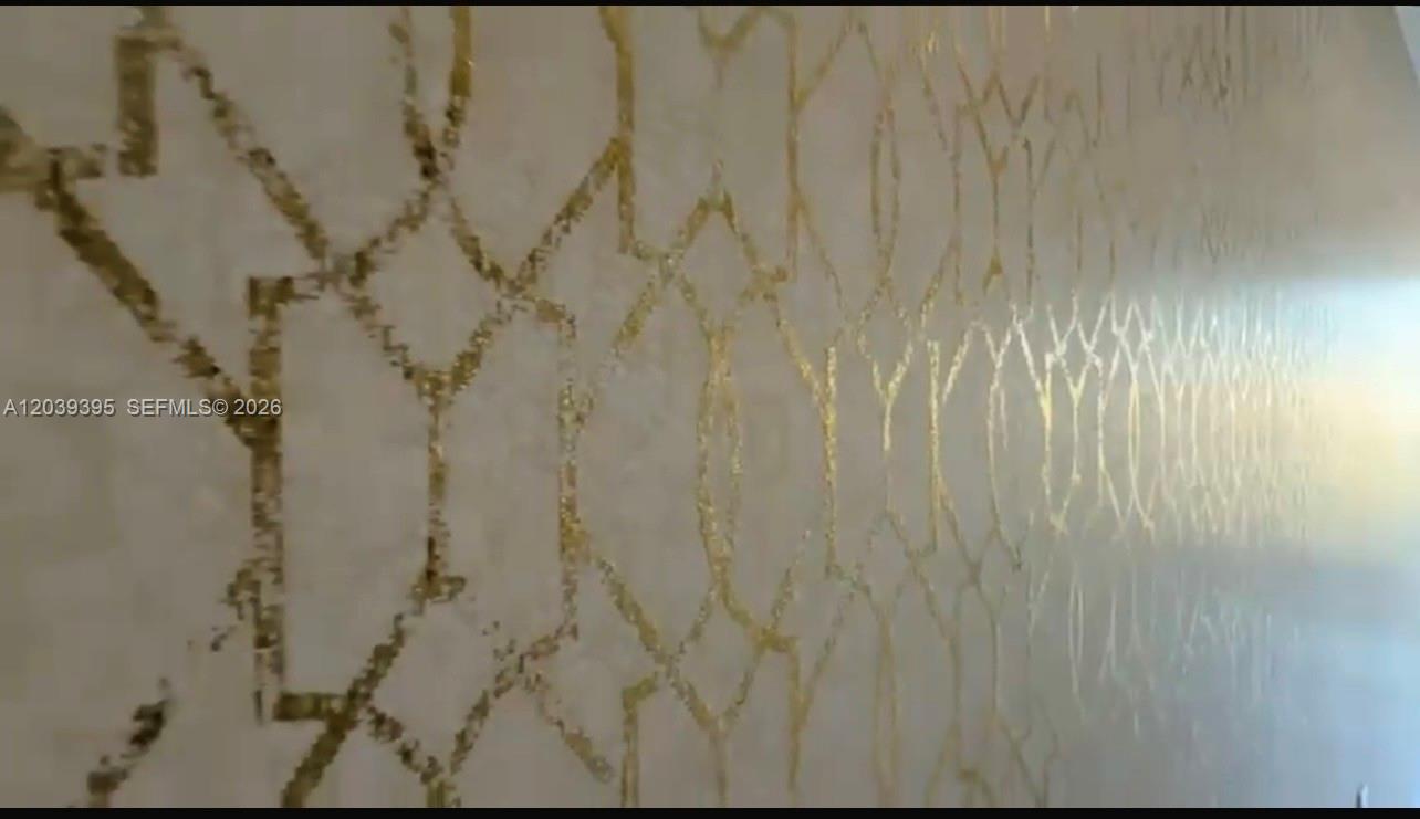 A close-up view of a wall featuring a metallic gold geometric lattice pattern — 700 NE 24th St # 1505, Miami FL 33137, MIAMI, FL