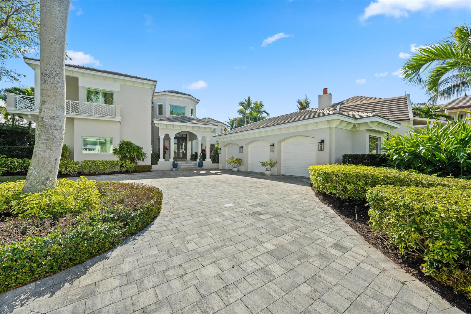 A two-story house with a paved driveway, a two-car garage, and lush landscaping — 116 Terrapin Trail, Jupiter FL 33458, JUPITER, FL