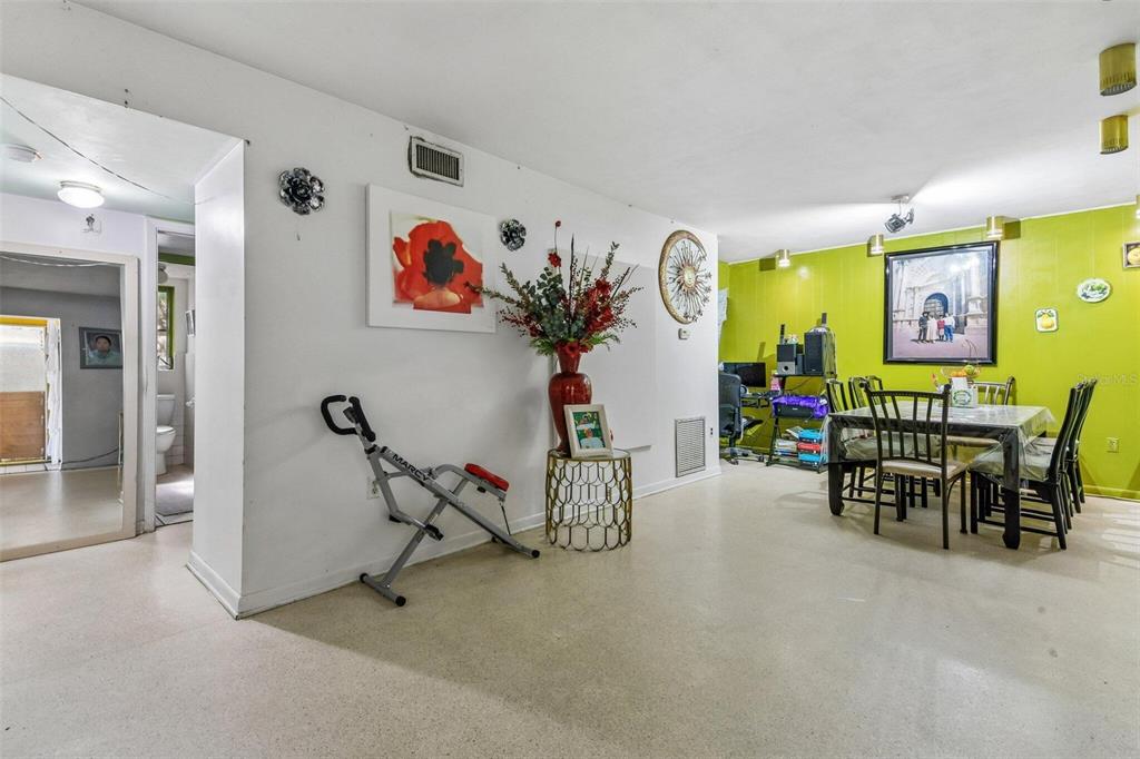 A living room features a built-in white cabinet, two leather recliners, and a television console — 1267 FRANKLIN STREET, CLEARWATER, FL