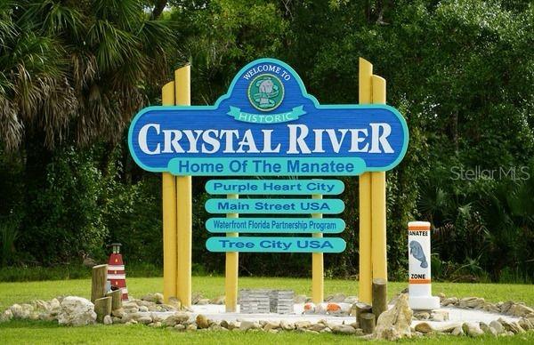 A blue and yellow sign welcomes visitors to Historic Crystal River, Home of the Manatee — 8400 W MAYO DRIVE, CRYSTAL RIVER, FL