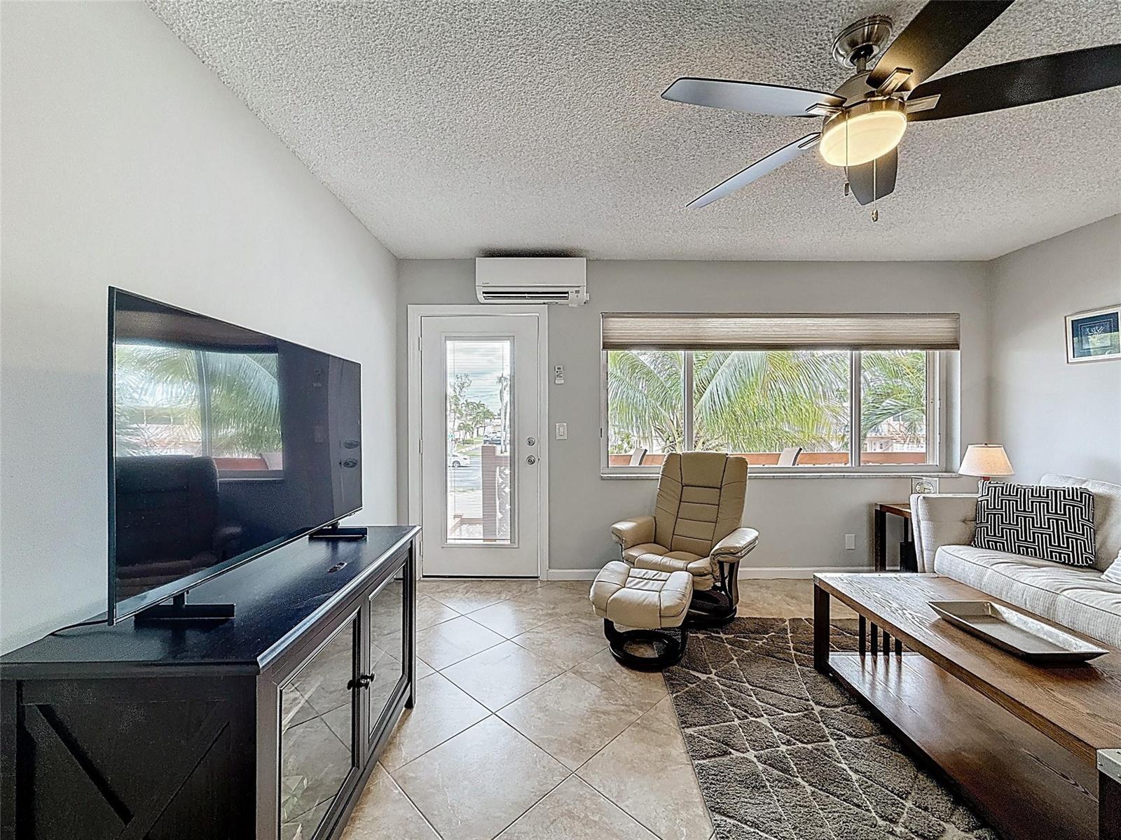 A living room features a television, a beige recliner with ottoman, and a sofa — 800 SW 11th Avenue # 12, Hallandale Beach FL 33009, HALLANDALE BEACH, FL