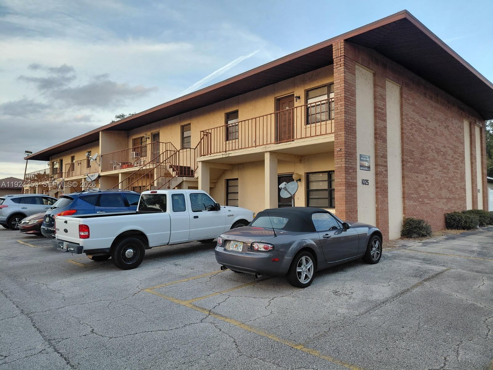 A two-story apartment building with a brick facade and a parking lot in front — 1025 LAKEVEIW DRIVE, Sebring FL 33870, SEBRING, FL