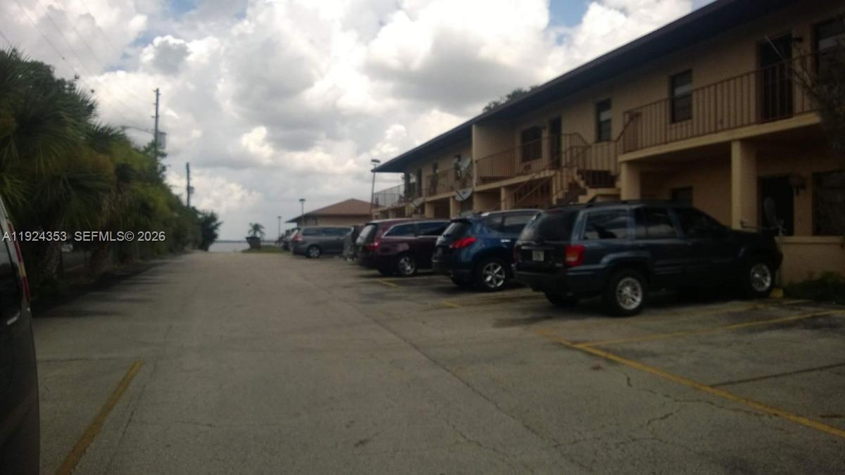 A parking lot sits in front of a two-story apartment building near the water — 1025 LAKEVEIW DRIVE, Sebring FL 33870, SEBRING, FL