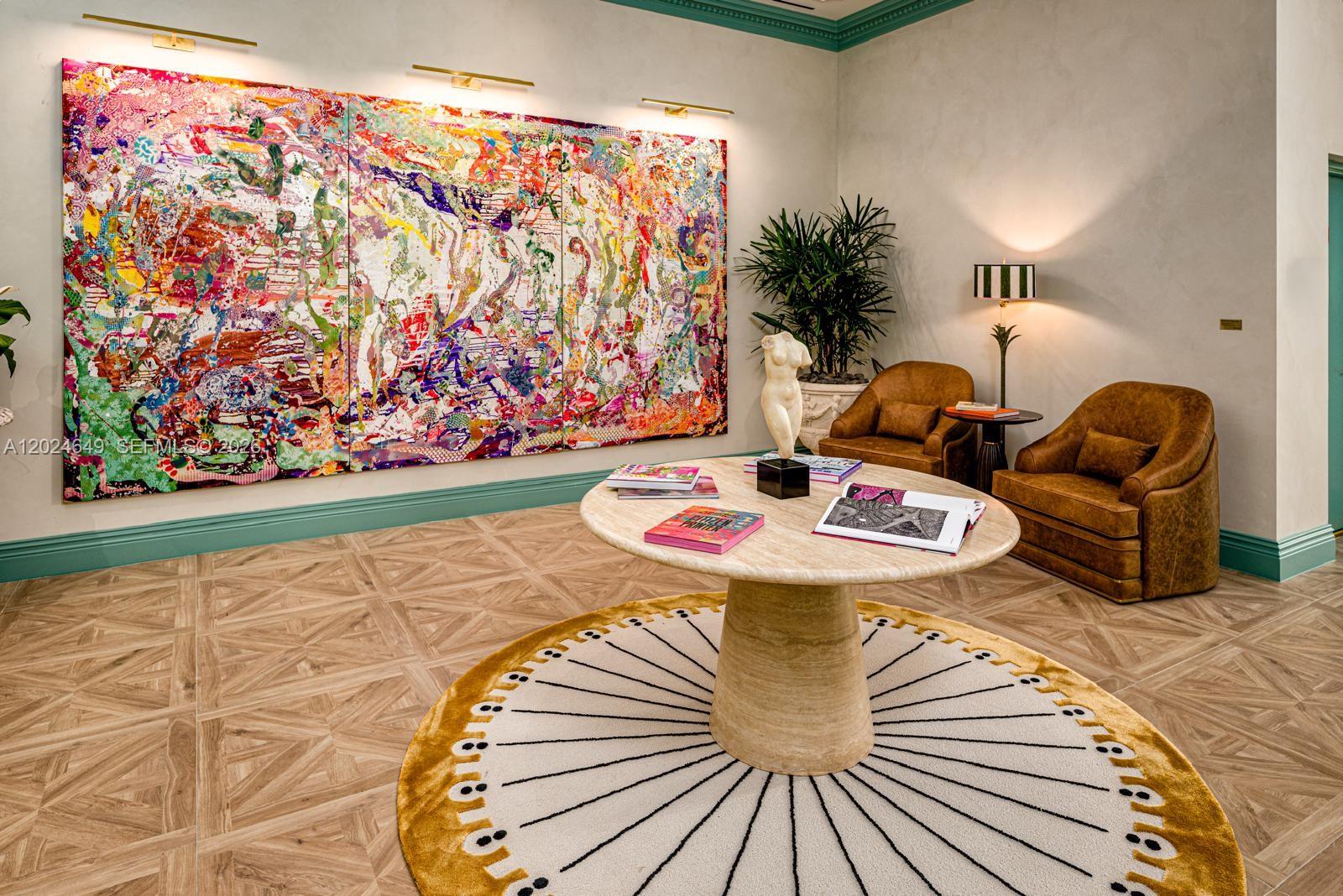 A lobby features a large abstract painting, a round stone table, and two leather armchairs — 2700 NW 2nd Ave # 233, Miami FL 33127, MIAMI, FL