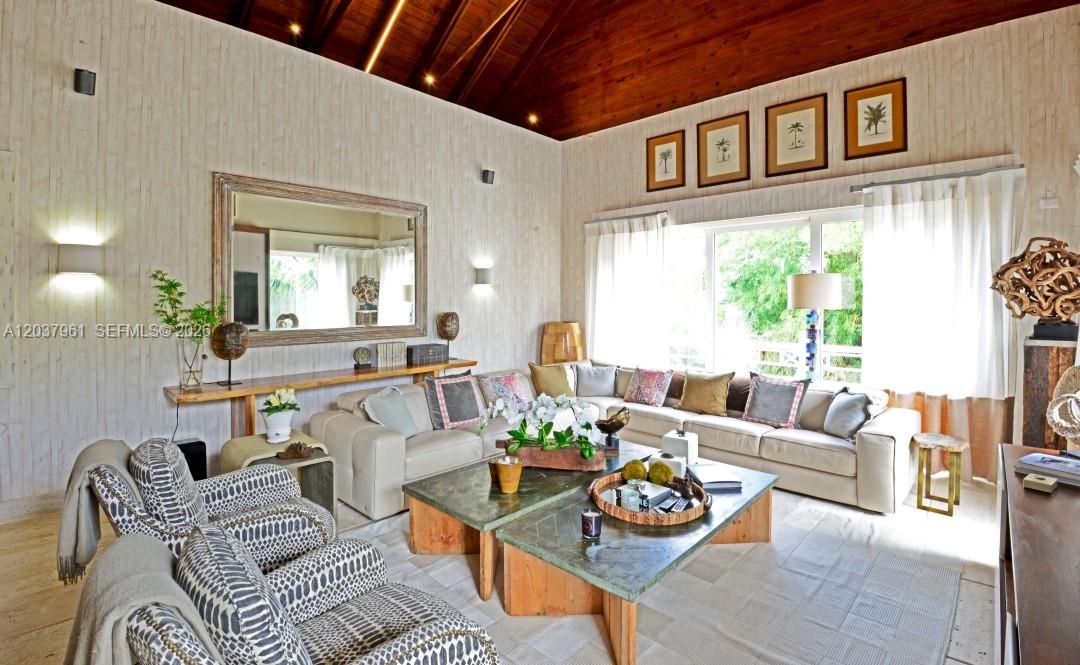 A living room features a vaulted wood ceiling, light-colored walls, and a large sectional sofa — 0 Juanillo Bay, FL