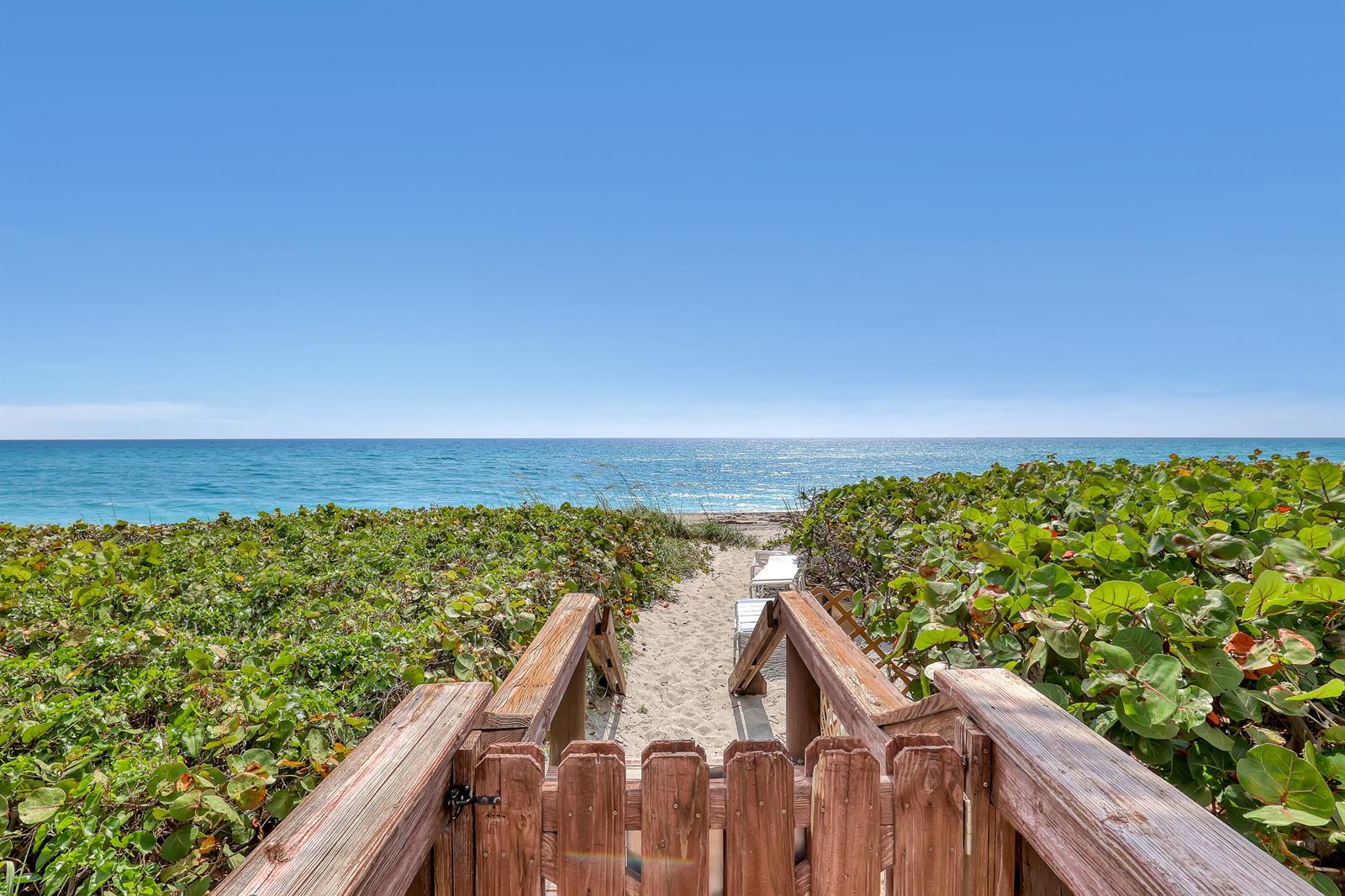 A wooden gate and staircase lead down a sandy path to a beach with ocean views — 220 Celestial Way # 6, Juno Beach FL 33408, JUNO BEACH, FL