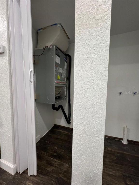 A utility closet contains a wall-mounted HVAC air handler unit and plumbing hookups for laundry — 1526 LAKEWOOD ROAD, DAVENPORT, FL