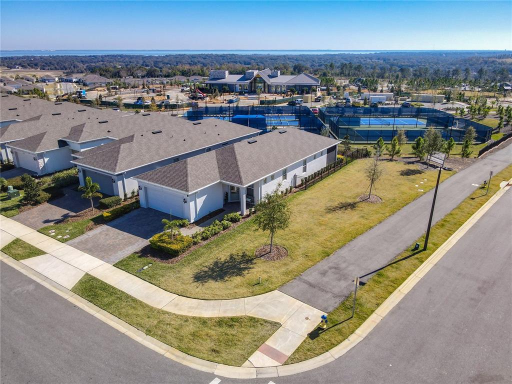 An aerial view shows a suburban house with a side-entry garage and a corner lot — 2750 PURPLE MEADOW COURT, MINNEOLA, FL