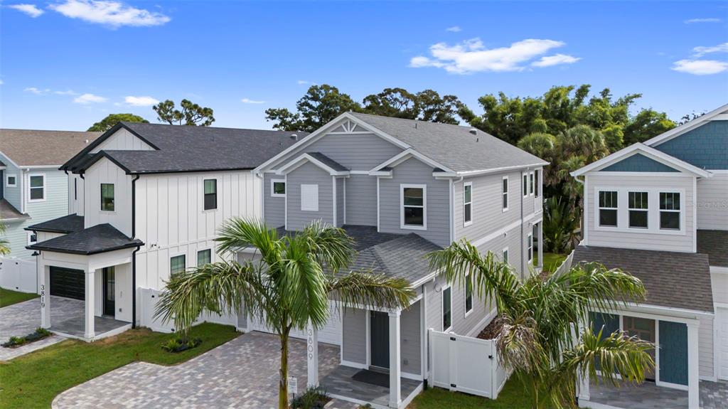 An aerial view shows three modern two-story houses with gray and white siding — 3809 71ST STREET N, ST PETERSBURG, FL