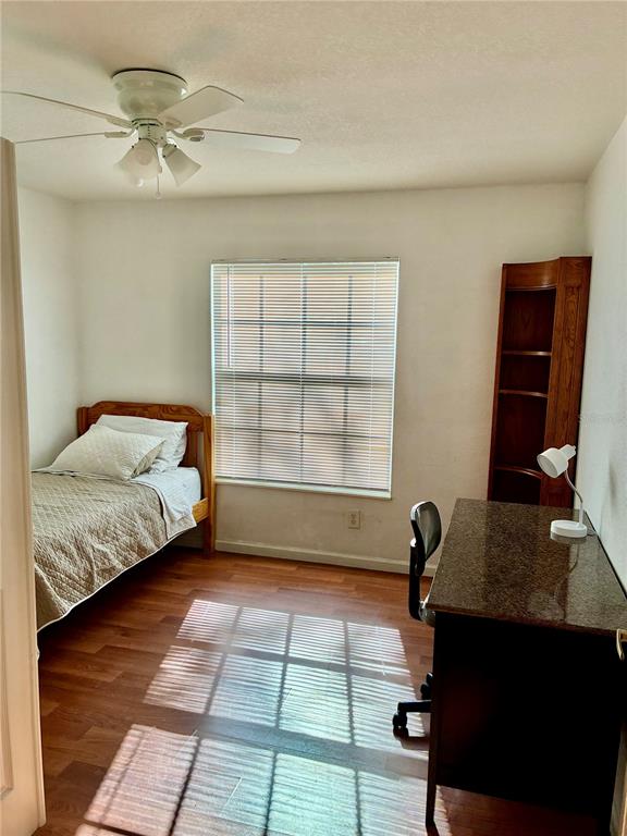 A bedroom features a single bed, a desk with a lamp, and a corner shelf — 4122 RESIDENCE DRIVE UNIT 120, FORT MYERS, FL