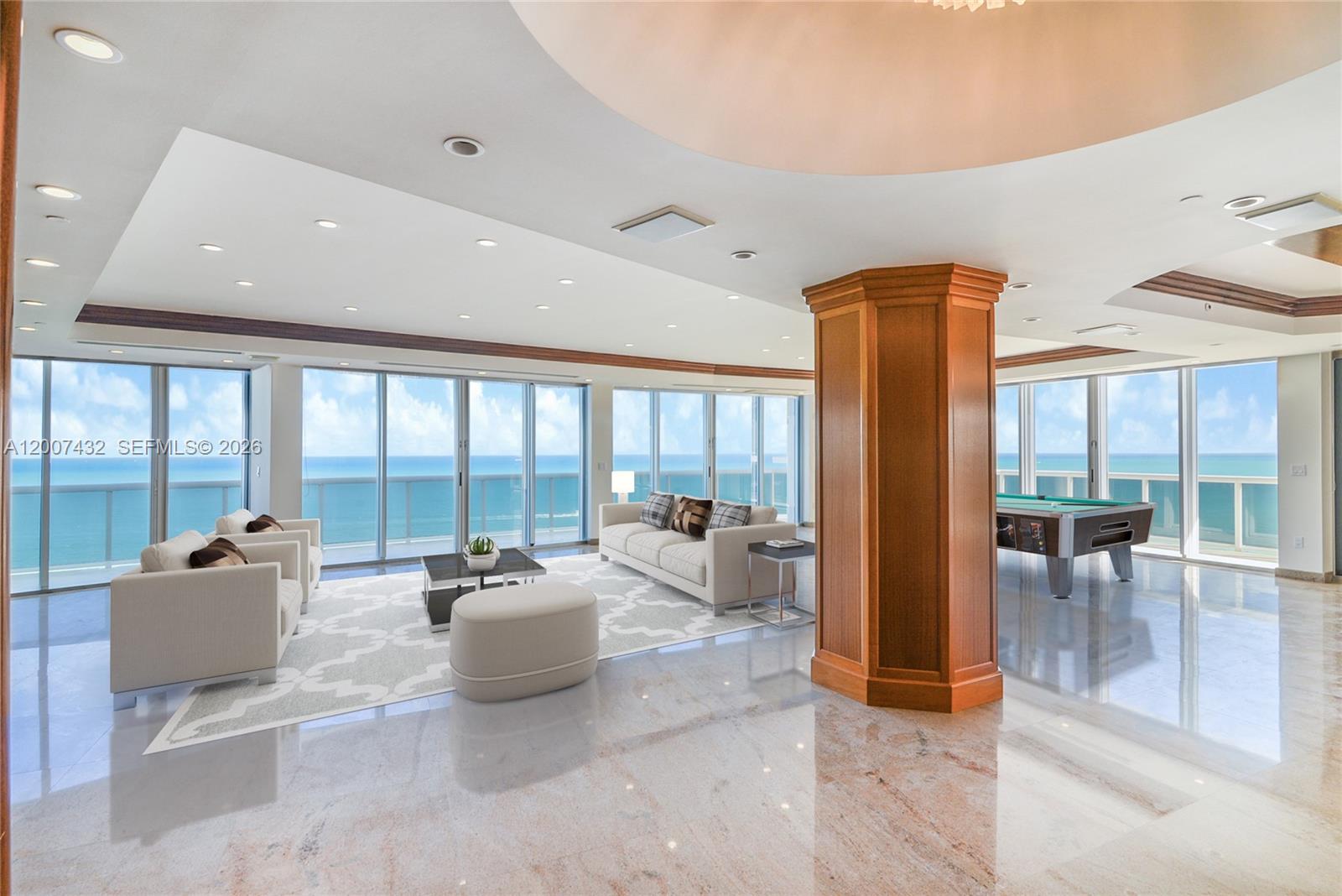 A spacious living room features marble floors, a wooden column, and floor-to-ceiling ocean views — 9601 Collins Ave # T4, Bal Harbour FL 33154, BAL HARBOUR, FL