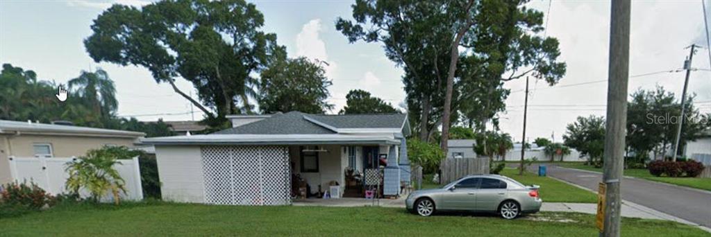 A single-story house with a white lattice-enclosed porch and a silver car parked outside — 6500 HOBSON STREET NE, ST PETERSBURG, FL