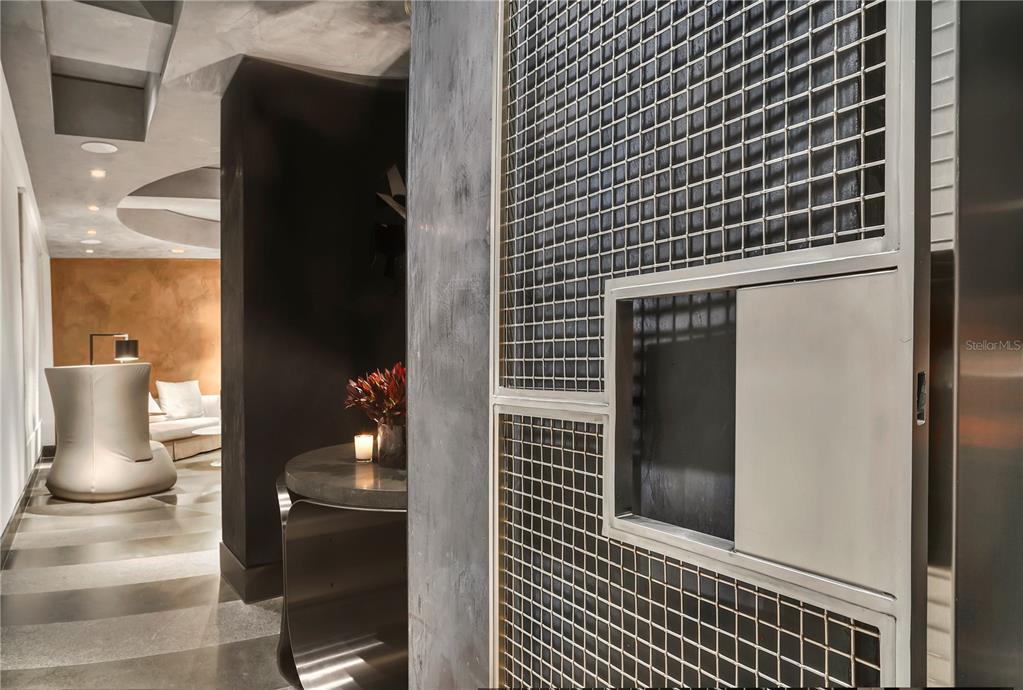 A modern interior features a metal grid partition, a curved console table, and a lounge area — 1800 MCLEARY UNIT PH 2, SAN JUAN, PR