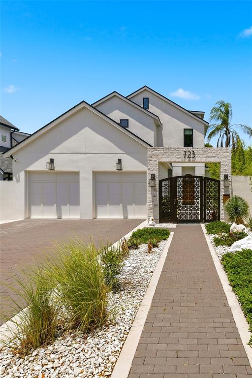 A modern two-story house with a two-car garage and a decorative metal gate entrance — 723 SYMONDS AVENUE, WINTER PARK, FL