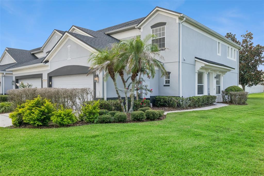 A two-story house with a gray exterior, a two-car garage, and a manicured lawn — 1431 SHALLCROSS AVENUE, ORLANDO, FL