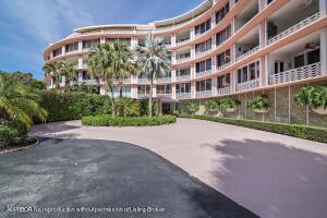 A curved, multi-story residential building with pink trim and balconies overlooks a paved driveway — 315 S Lake Drive # D, Palm Beach FL 33480, PALM BEACH, FL