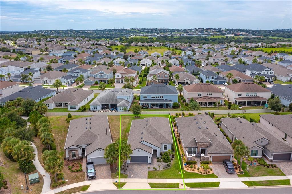 An aerial view shows a suburban neighborhood with a highlighted single-family home in the foreground — 1355 ZEEK RIDGE STREET, CLERMONT, FL