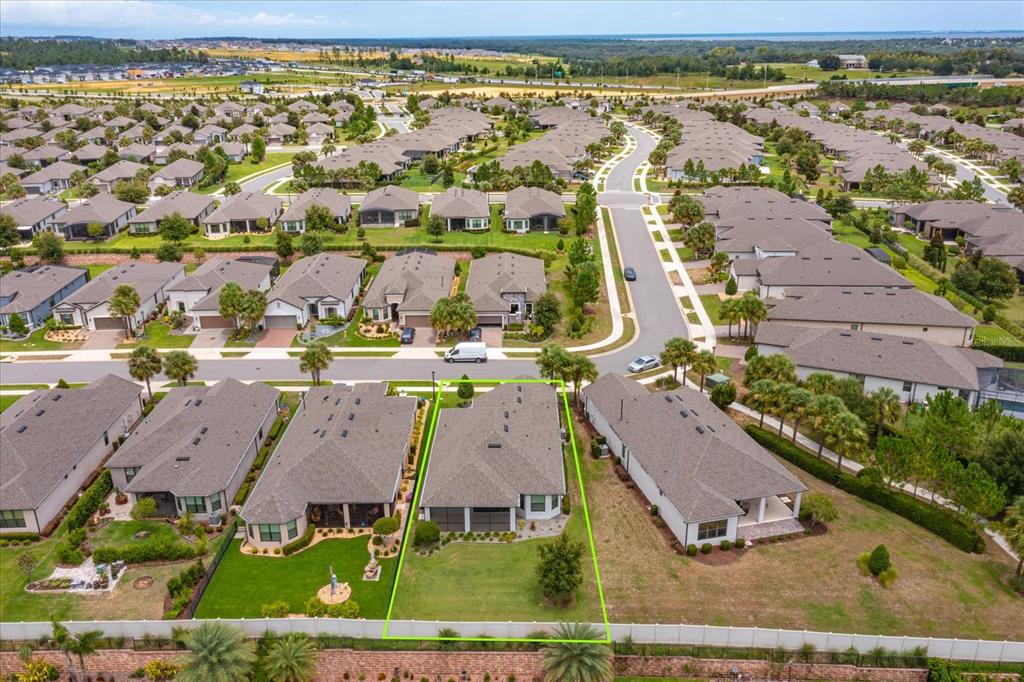 An aerial view shows a suburban neighborhood with a highlighted single-family house and backyard — 1355 ZEEK RIDGE STREET, CLERMONT, FL