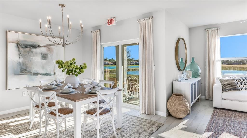 A dining area features a wooden table, white chairs, a chandelier, and sliding glass doors — 25252 ALCAZAR DRIVE, PUNTA GORDA, FL