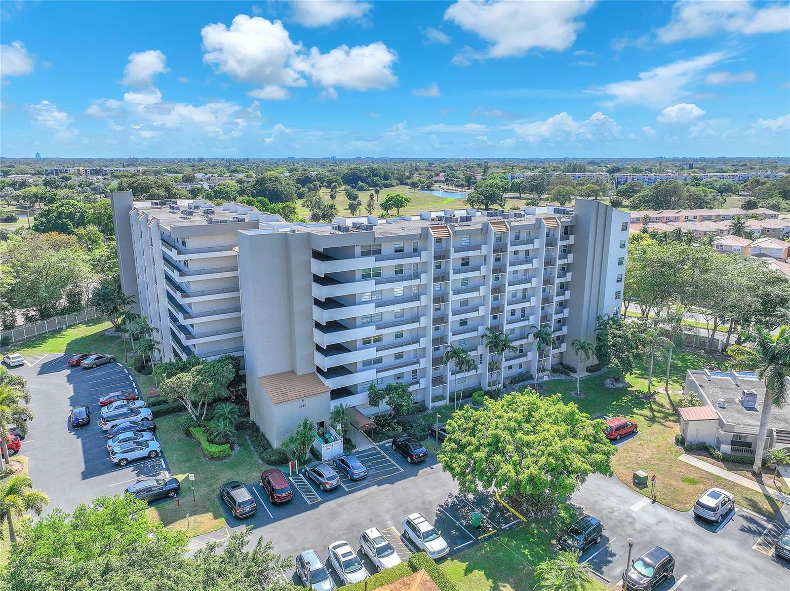 A kitchen features light wood cabinets, stainless steel appliances, granite countertops, and a dining table — 3910 Inverrary Boulevard # B, Lauderhill FL 33319, LAUDERHILL, FL