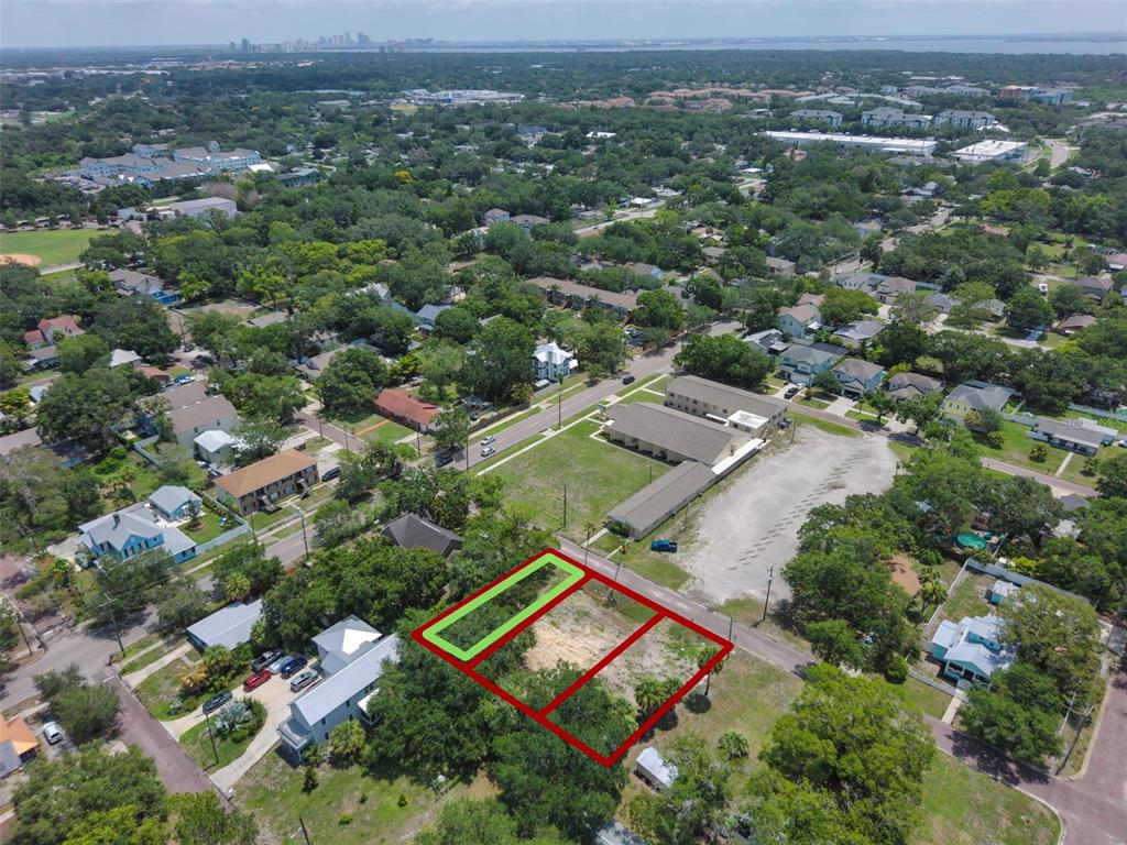An aerial view shows three adjacent vacant lots outlined in red and green — 6905 S SPARKMAN STREET, TAMPA, FL