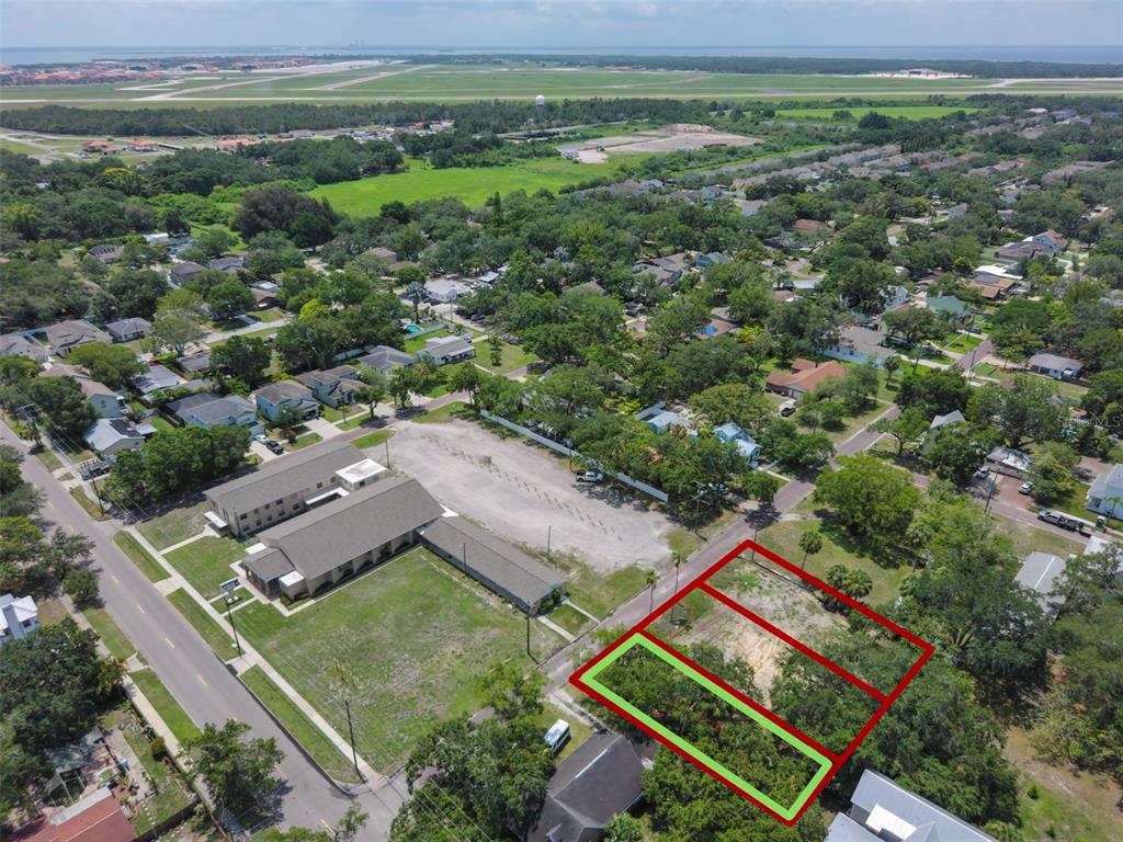 An aerial view shows two adjacent vacant lots highlighted in red and green — 6905 S SPARKMAN STREET, TAMPA, FL