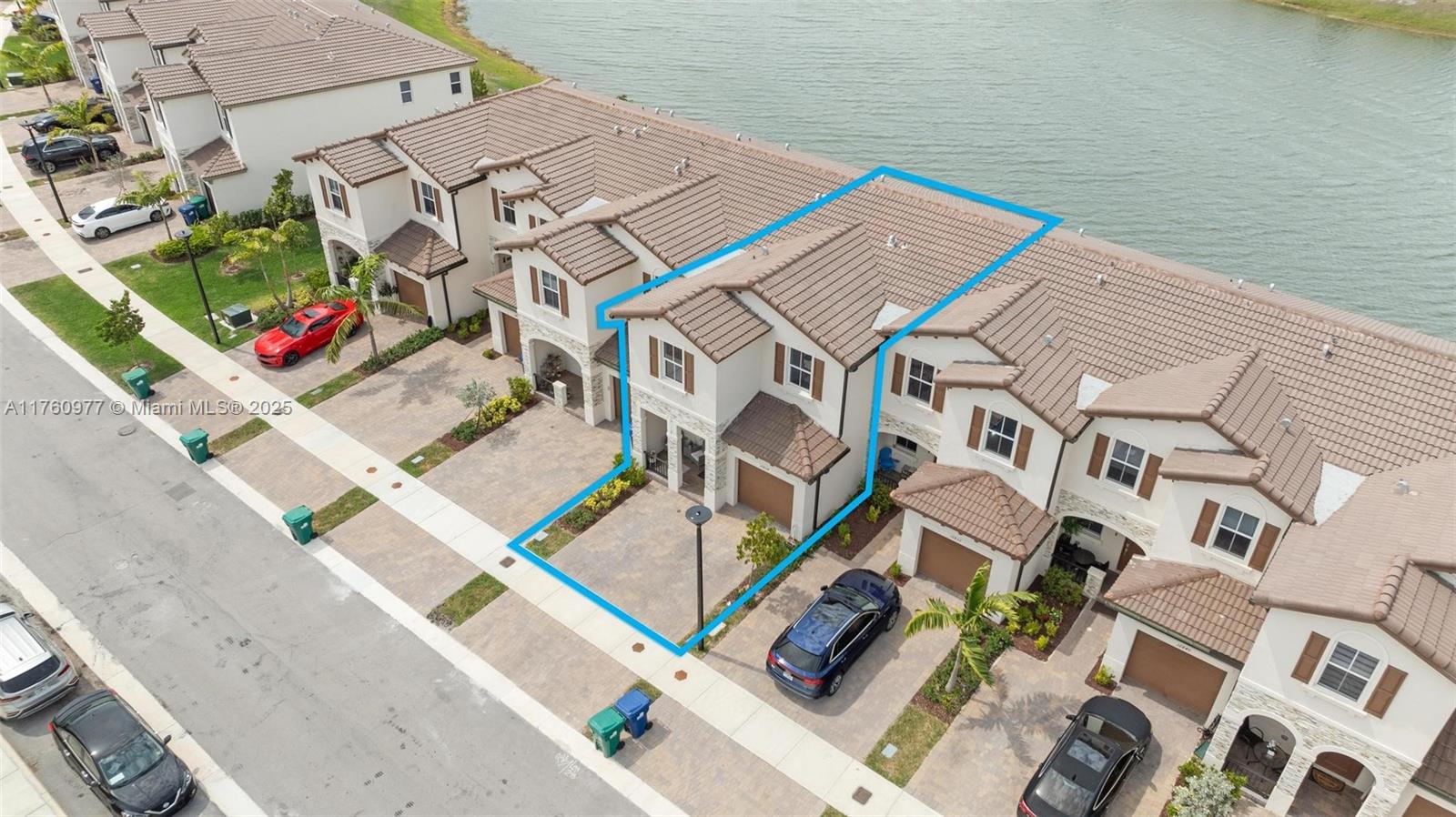 An aerial view shows a two-story townhouse with a tiled roof and a paved driveway — 12824 NW 22nd Pl # 12824, Miami FL 33167, MIAMI, FL